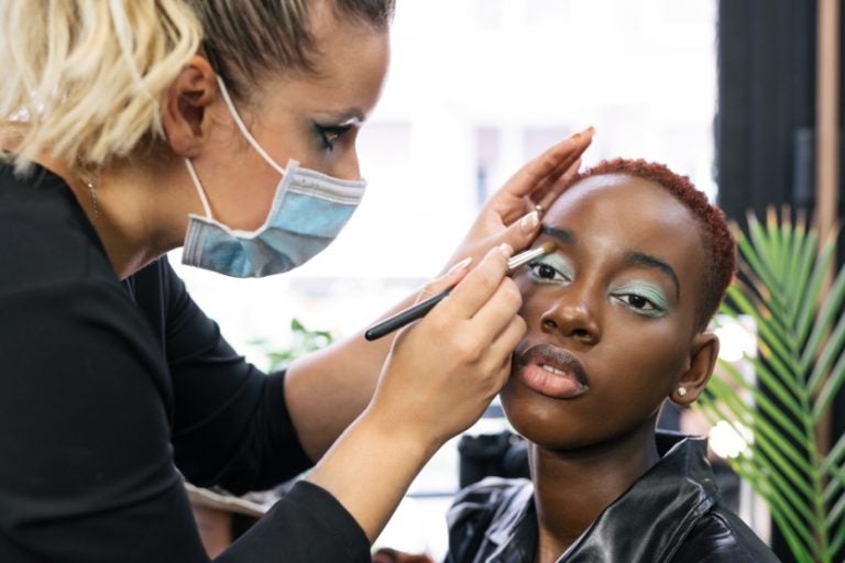 Makeup,artist,making,up,the,eyes,of,a,black,girl