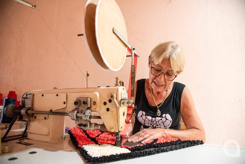Dona de casa de Umuarama costurando tapete.