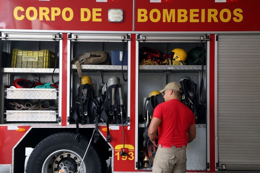 Militar do Corpo de Bombeiros próximo a um caminhão ABTR.