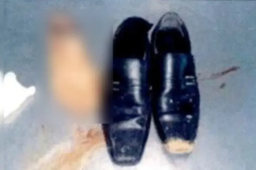 Um par de sapatos próximo a um membro borrado.