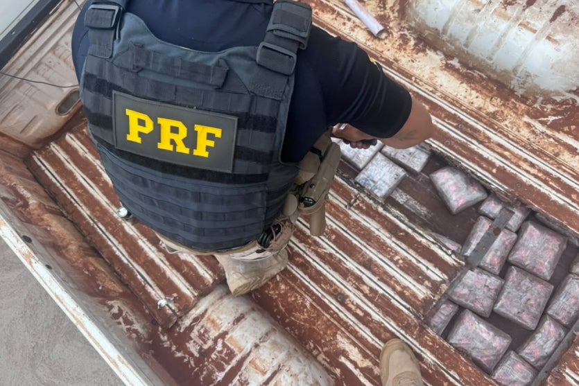 Agente da PRF descobrindo caminhão carregado com drogas na BR-487.
