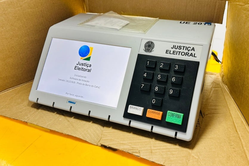 Urna eletrônica dentro da caixa.